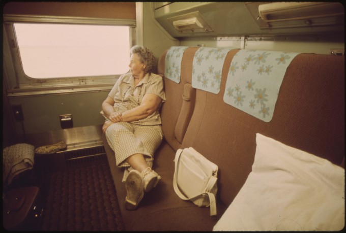 TRAVELER_RELAXES_IN_THE_PRIVACY_OF_HER_COMPARTMENT_ON_THE_EMPIRE_BUILDER_PASSENGER_TRAIN_ENROUTE_FROM_CHICAGO_TO_EAST..._-_NARA_-_556098